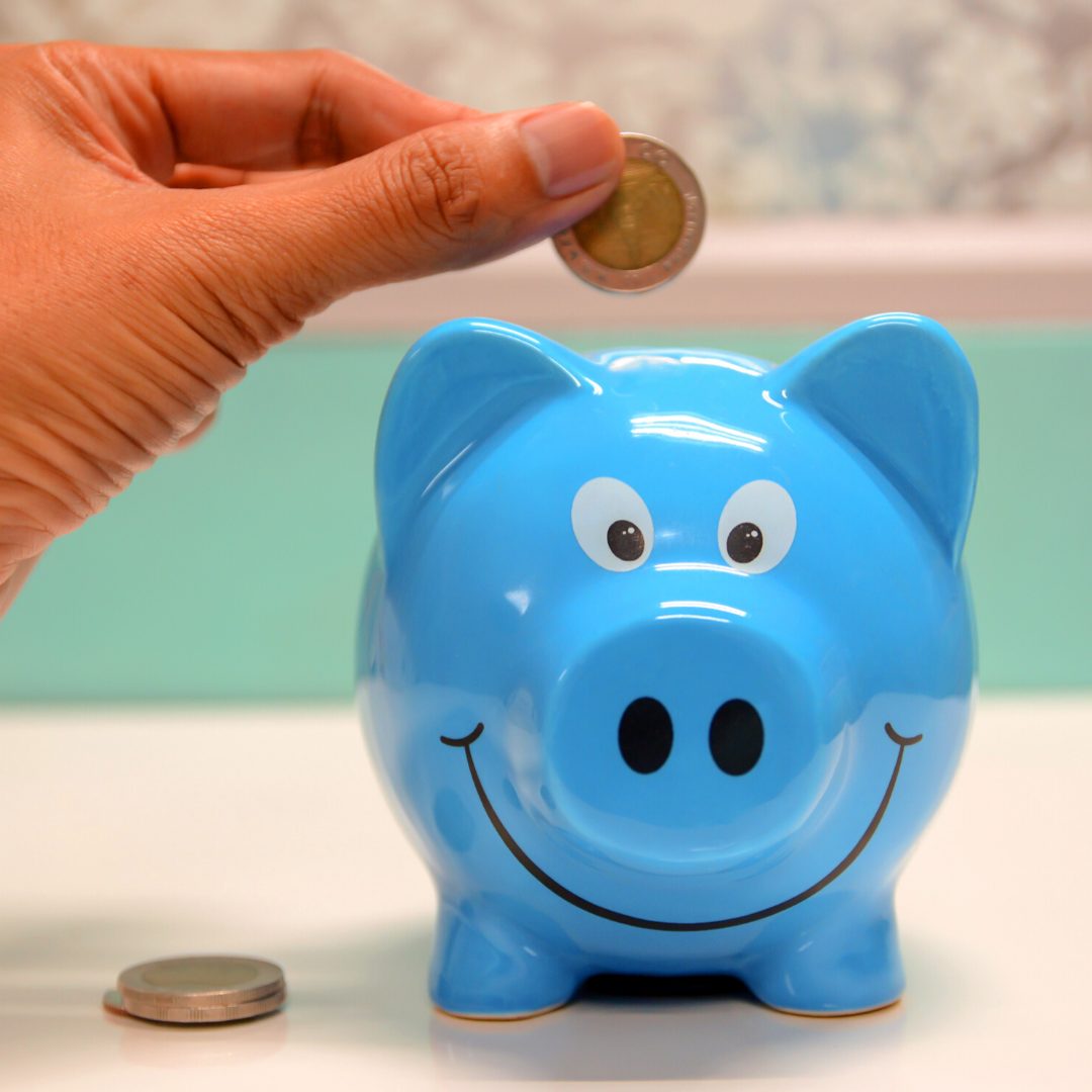blue piggy bank - spending and saving money